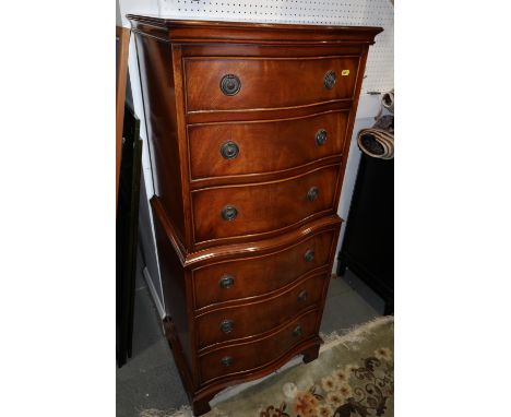 A figured mahogany serpentine front tallboy, fitted six drawers, on bracket feet, 21" wide x 16" deep x 55" high 