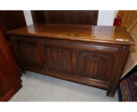 An oak coffer with triple linenfold panel front, on stile supports, 41 1/2" wide x 11 1/2" deep x 20" high, a&nbsp;Victorian 