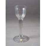 An 18th century cordial glass on folded foot, 5" high