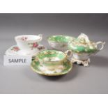 A Royal Crown Staffordshire floral decorated part teaset and 19th century green and gilt decorated