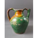 An early 19th century green and yellow glazed jug, 10" high