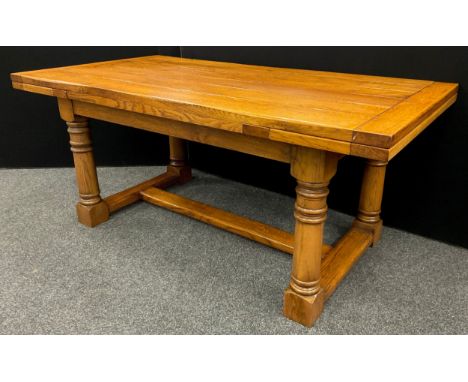 An oak plank-top refectory dining table, by Brampton Furniture, extendable draw-leaves, turned columnar supports, 78.5cm high