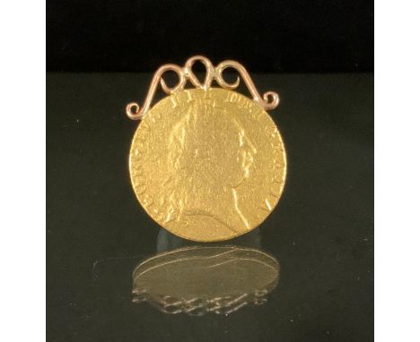 A George III Spade Guinea coin, Fifth laureate portrait of King George III right, GEORGIVS III DEI GRATIA· legend around, dat