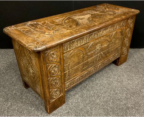 A carved oak blanket chest/coffer, the lift-up lid caved with faux hinge straps, and portrait bust of Henry VIII, Tudor inspi