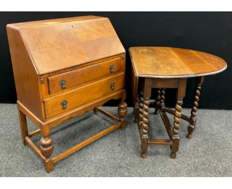 A 1930’s oak bureau, 99cm high x 76cm wide x 44cm deep; and a 1930’s oval-top drop-leaf table, barley-twist supports, 70cm hi