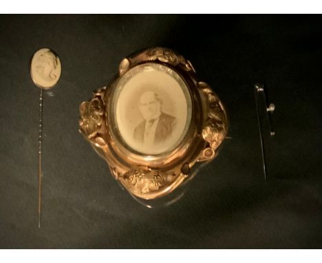 A Victorian lava cameo tie pin, oval portrait panel tip, unmarked spiralled shaft;  mourning brooch, revolving photographic c