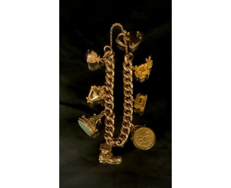 A 9ct gold charm bracelet, suspending a 1907 half sovereign, six 9ct gold and yellow metal charms, Balmoral Castel, seal stam