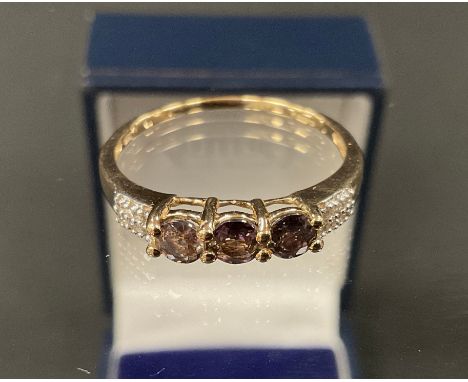 A diamond and three colour tourmaline dress ring, three mixed cut tourmalines between diamond set double row shoulders, 9ct g