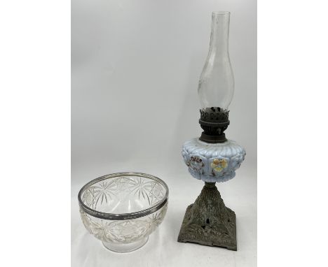 A cut glass bowl with hallmarked silver rim along with an antique oil lamp