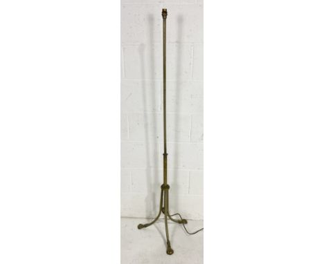 A vintage brass standard lamp on tripod base