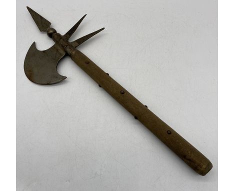 A medieval style battle axe with studded wooden handle