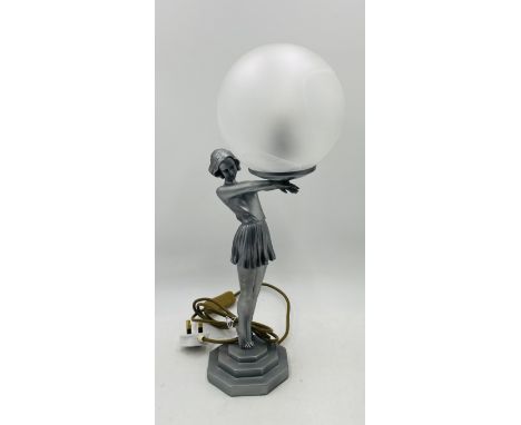 An Art Deco style table lamp in the form of a young lady holding a globe - Overall height 50cm