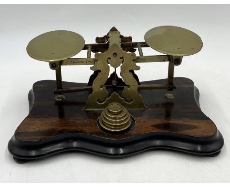 A set of brass postal scales and weights on coromandel base by Martin & Co, Cheltenham 