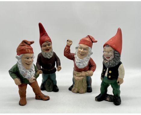 Four weathered terracotta garden gnomes, all missing tools. Height 31cm approx.