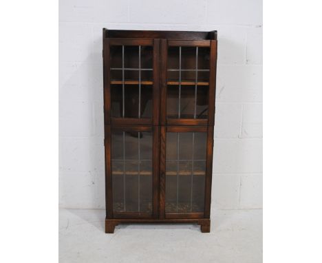 An oak display cabinet, with four doors with leaded light detailing - length 58cm, depth 19.5cm, height 110.5cm