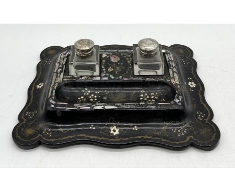A Victorian papier mâché inkwell with inlaid mother of pearl detail