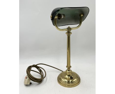A brass bankers lamp with green glass shade 