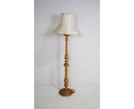 A gilt standard lamp with silk shade