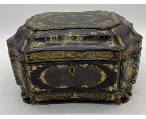 A 19th century Chinese lacquered tea caddy with pewter internal cannisters, on gilt feet