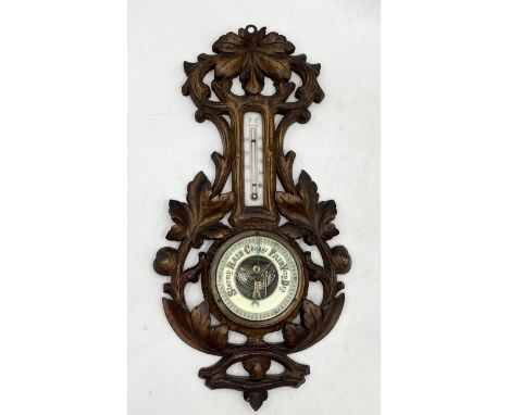 A carved wooden barometer, made in Germany 