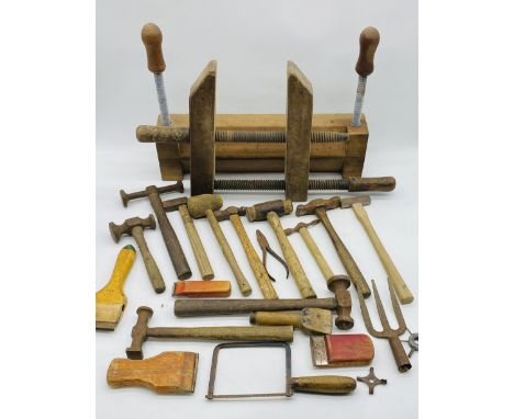 A small collection of tools including several hammers, saw, wooden scrapers etc