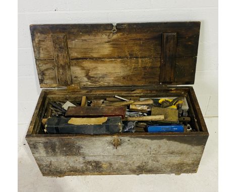 A wooden carpenter's truck, full with various tools including hammers, chisels, drill bits, axes etc  