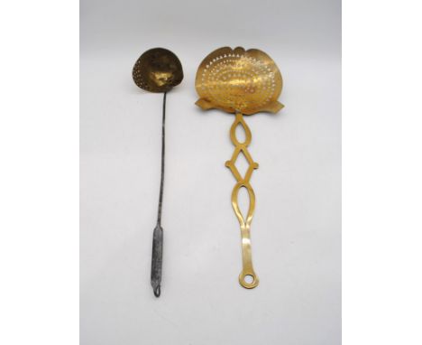 An antique brass strainer ladle along with a brass skimmer