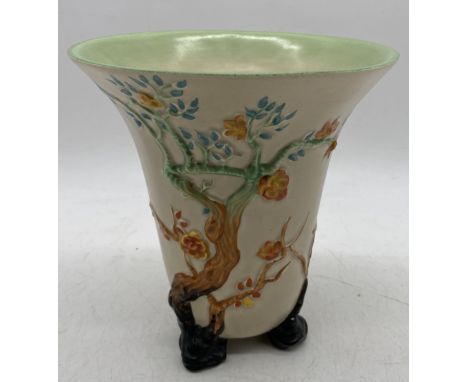 A Clarice Cliff trumpet shaped vase decorated with branches and foliage, height 20cm