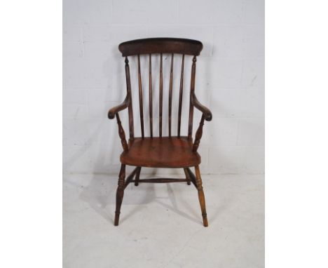 An antique stick-back Windsor chair, marked '141, G.T' 