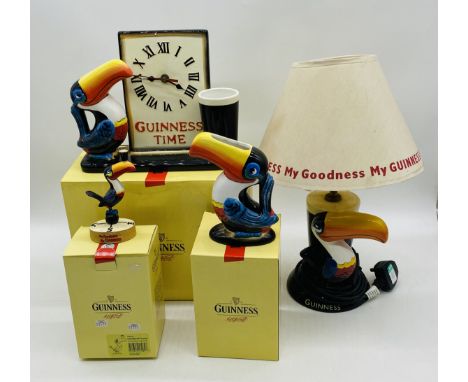 Three boxed Guinness Toucan ceramics by Enesco including a clock, small jug and collectable figurine, along with a Guinness t