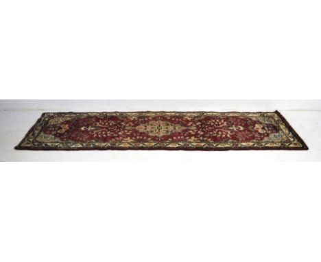 A red ground Eastern runner - 292cm x 82cm