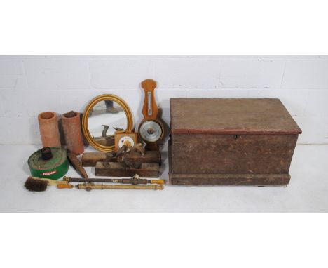 A wooden trunk containing various items, including a wall barometer, gilt framed wall mirror, terracotta pipes etc.