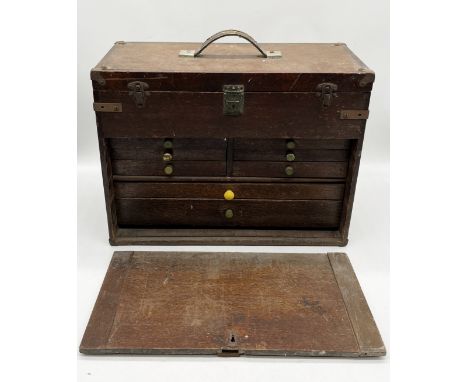An engineers oak toolkit with numerous tools including Moore & Wright Callipers, various spanners etc. (front needs attention
