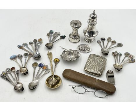 A collection of silver plated items including pepper grinder, sugar caster, spoons etc.