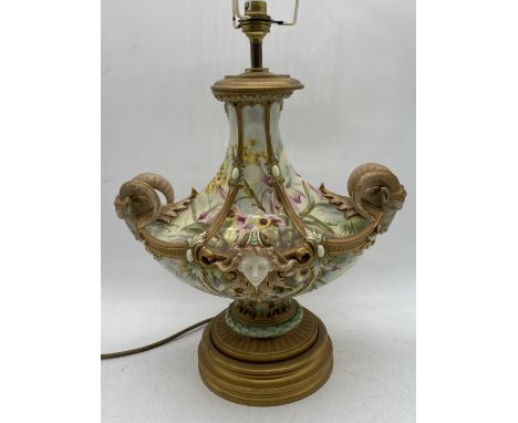 An impressive Royal Worcester lamp with hand painted floral decoration, twin rams head handles and Art Nouveau masks, overall