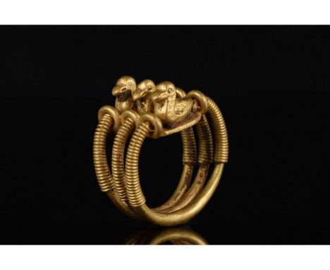 C. 200 BC. Celtic iron age. Gold ring comprising three hoops with filigree-decorated shoulders, joined by a bezel surmounted 