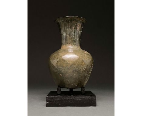 100-300 AD. Roman. Bronze wine vessel with flaring rim, truncated conical neck, rounded shoulder, inward-flaring body and fla