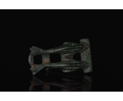 100-300 AD. Roman. Bronze brooch comprising two rectangular bars joined by two stylised leaping dolphins, which feature caref