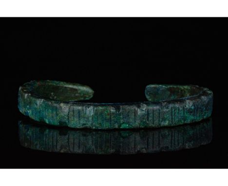 700-1100 AD, Viking Age. A heavy bronze bracelet with incised linear decoration, and striations on the terminals thought to b