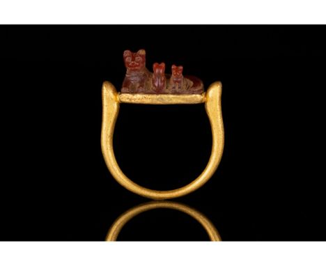 1550-1070 BC. Late New Kingdom. Gold ring with D-shaped hoop and projecting shoulders; a rectangular plaque between the two s