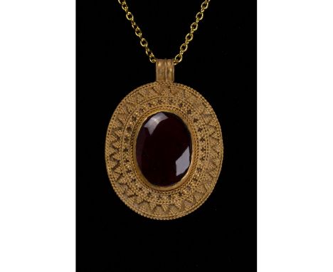 100-300 AD. Roman. Gold medallion comprising a circular suspension loop with ribbed decoration on the exterior and an oval-sh