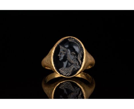 C. 100-300 AD. Roman. Gold ring comprising D-shaped hoop and elliptical bezel with a black gem setting. The setting bears an 