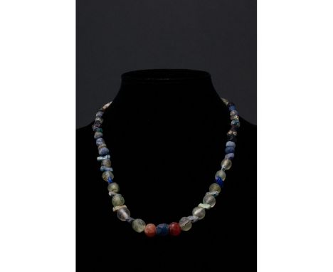 Ca. 100-300 AD. Roman. A restrung necklace of Roman beads comprising multiple opaque and transparent sub-spherical, and squar