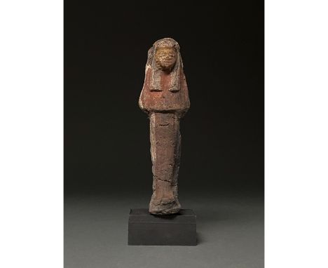 Ca.1070-945 BC Egyptian. Beautiful buff-coloured ceramic ushabti figure wearing a tripartite wig and robe and standing with c
