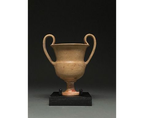 C. 400-300 BC. South Italian. Cream-coloured krater with large ear-shaped handle, out turned rim, bell-shaped body, round ste