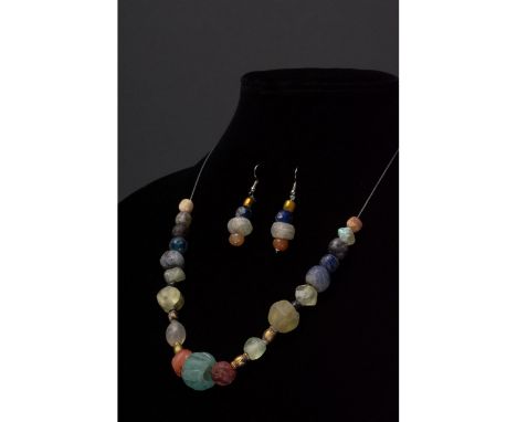 Ca. 100-300 AD. Roman. A restrung set of earrings and a necklace of Roman beads comprising multiple opaque and transparent su