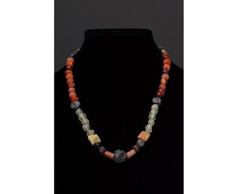 Ca. 100-300 AD. Roman. A restrung necklace of Roman beads comprising multiple opaque and transparent sub- spherical, tubular 