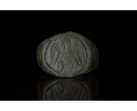 100-200 AD. Roman. Bronze ring with round hoop and flattened, circular bezel bearing an incised eagle motif. An aquila (eagle