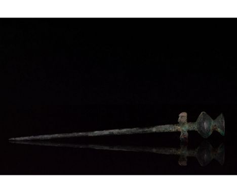 Ca.1300-600 BC. Bronze Age Luristani culture. Bronze cloth pin comprising a round-sectioned shank and stylised poppy-head ter