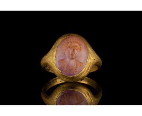 C. 100-300 AD. Roman. Gold ring comprising D-shaped hoop and elliptical bezel with a carnelian setting. The setting bears an 